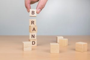 brand word written on wooden block - OneCity Technologies Pvt Ltd